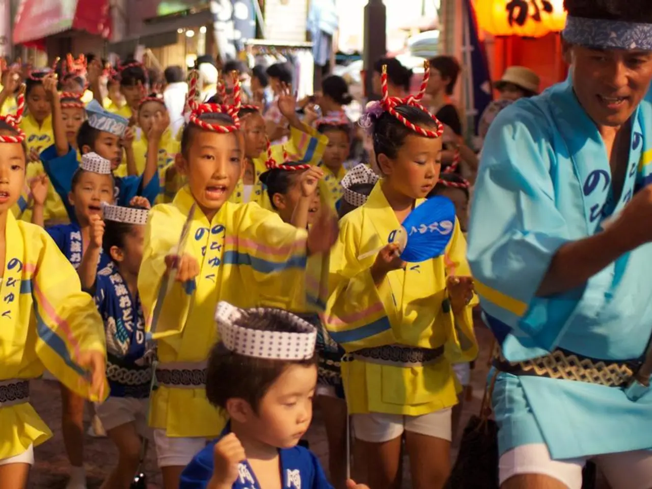 In this image, we can see some kids standing and wearing caps. There is a kid in the middle of the...