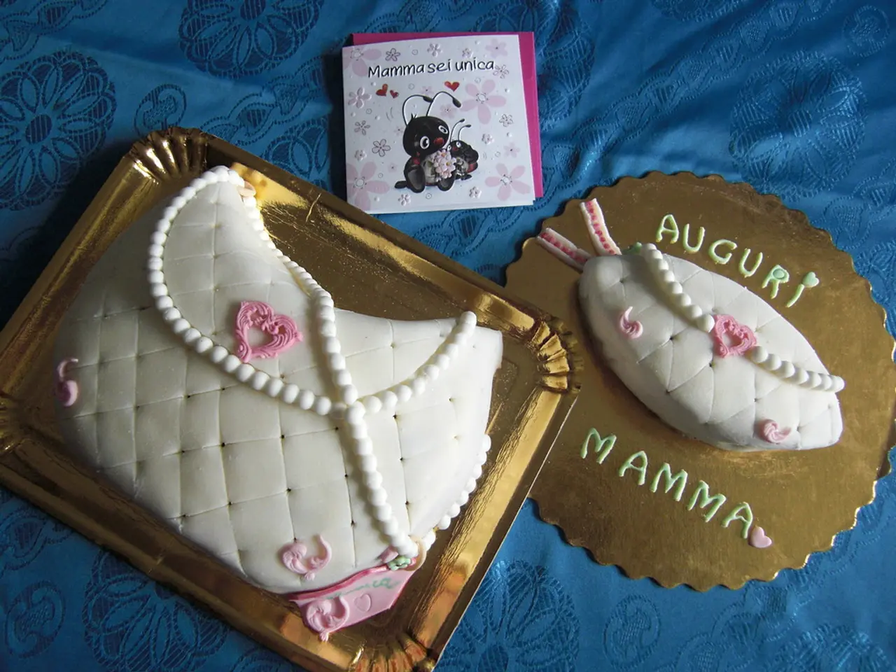 In this picture we can see white color two cakes are placed on the table covered with blue cloth....