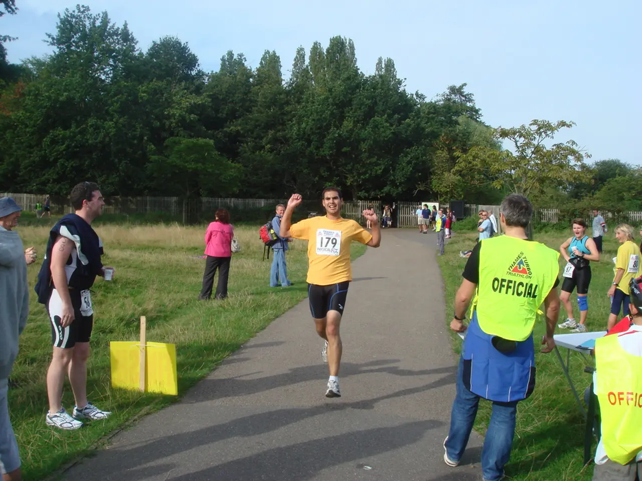 The man in the middle of the picture is running on the road. On either side of the picture, we see...