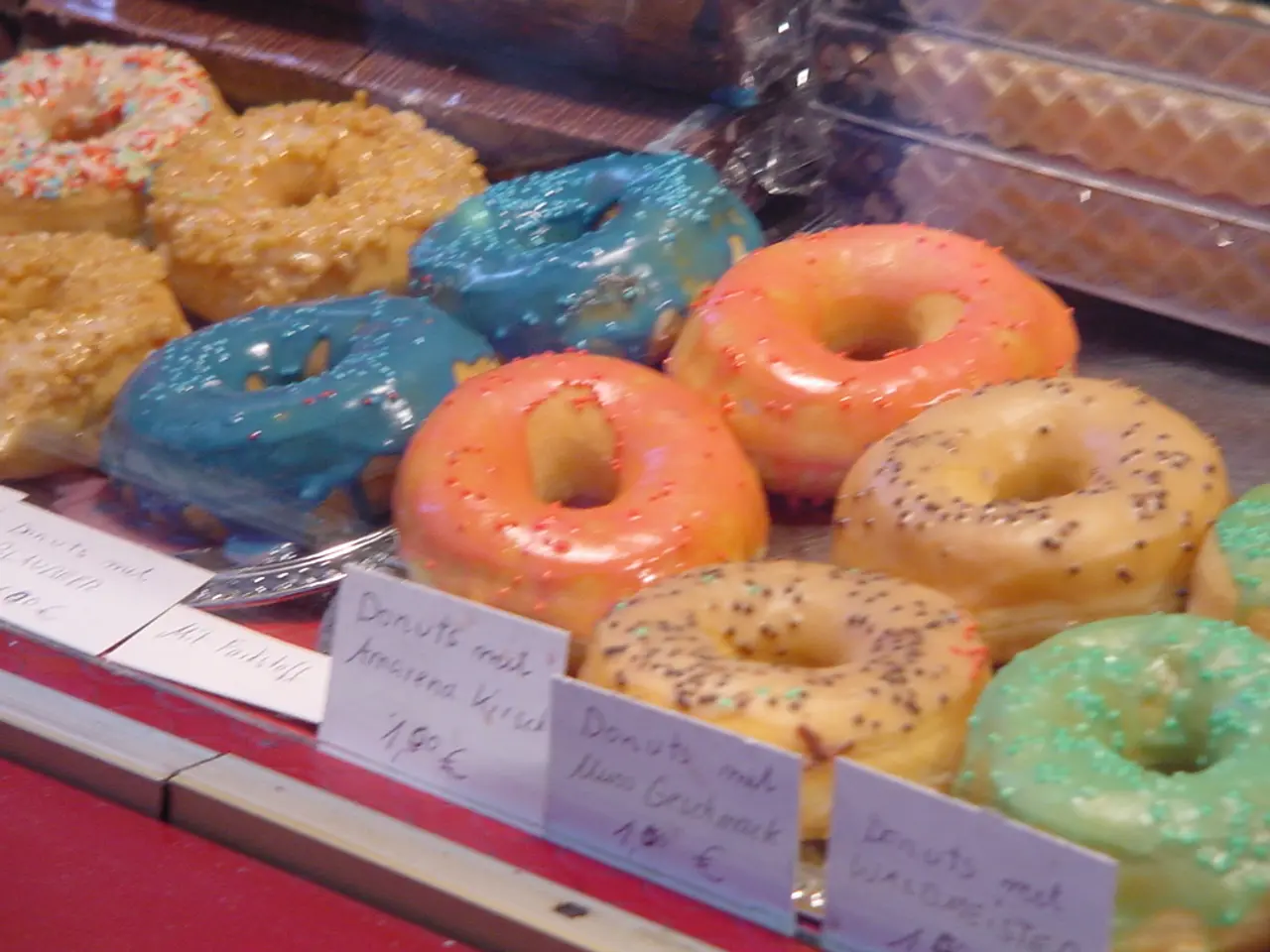 In the image we can see there are many donuts of different color. This is a name and price tag.