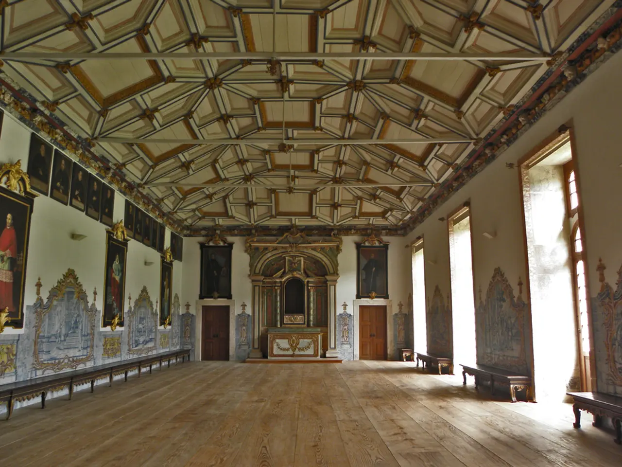 In this image we can see the interior view of a hall where there are frames attached to the walls,...