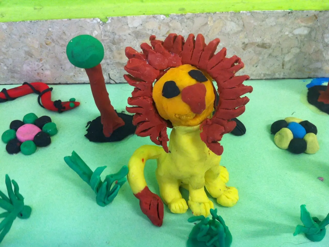 At the bottom of the image there is a table and we can see toys made of clay placed on the table.