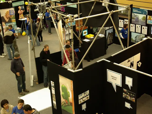 In this image there are people standing on a floor and there are stalls, on that there are some...