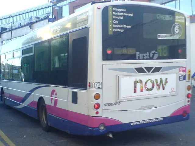 In this image we can see a bus is on the road. In the background, we can see the buildings and...