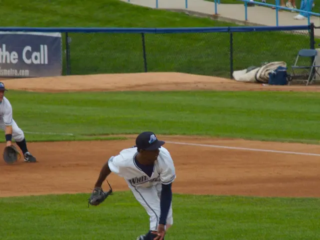 In this picture we can see two persons are playing baseball game, they wore caps and gloves, at the...