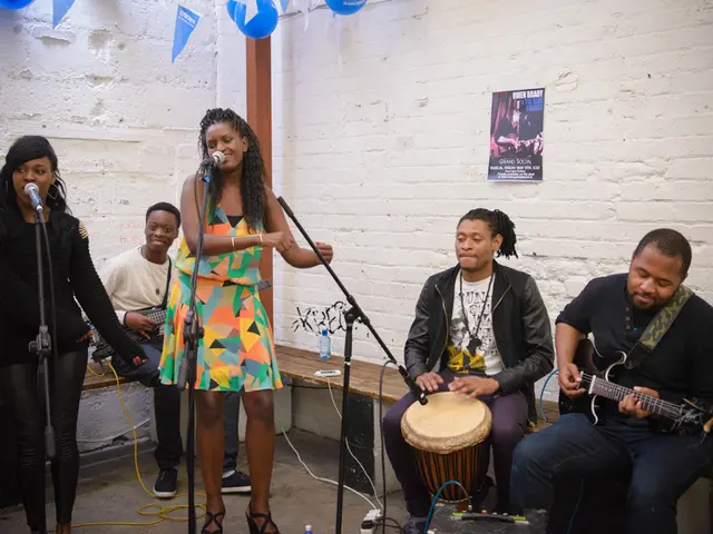 In this picture we can see five people among them there are sitting and playing some musical...