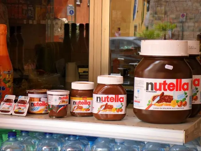 This picture is consists of chocolate bottles, which are placed on the table and there are two...