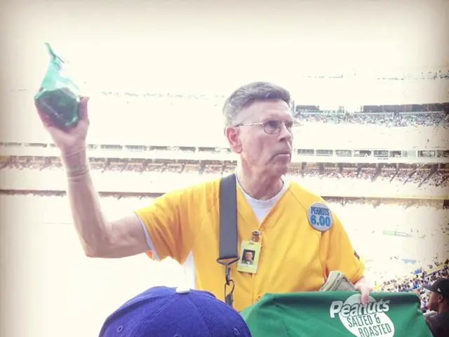 In this picture we can see a man wore spectacles, carrying a bag and holding a packet with his hand...