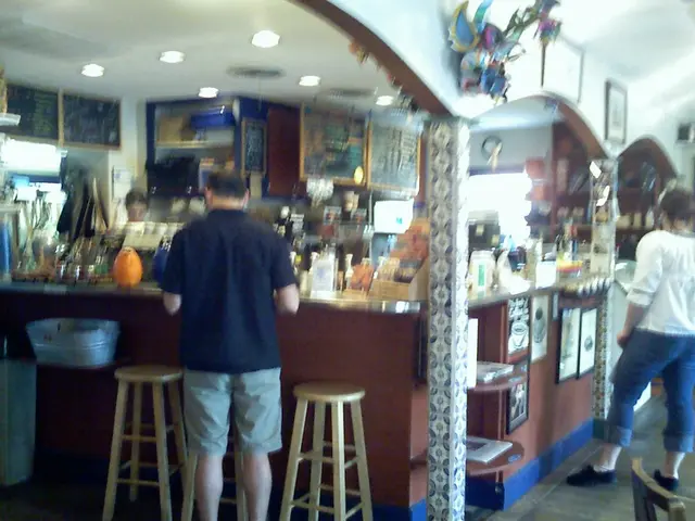 This picture shows a store where we see two people standing and watching the items and we see a...