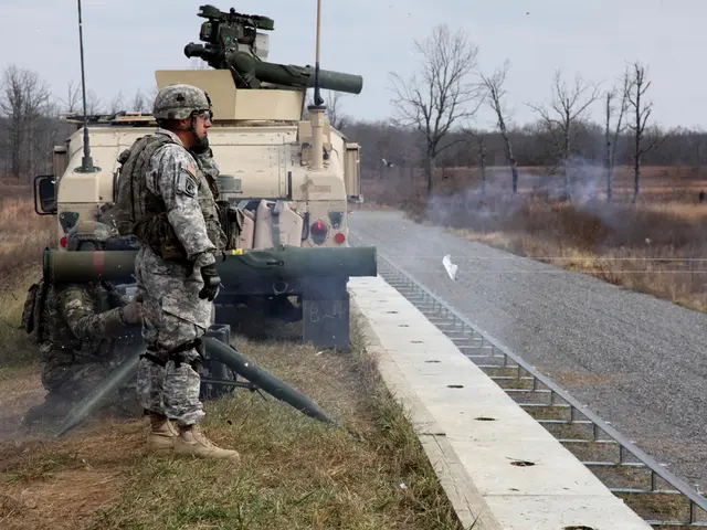 On the left side of the image we can see tanker, missiles and persons. On the right side of the...